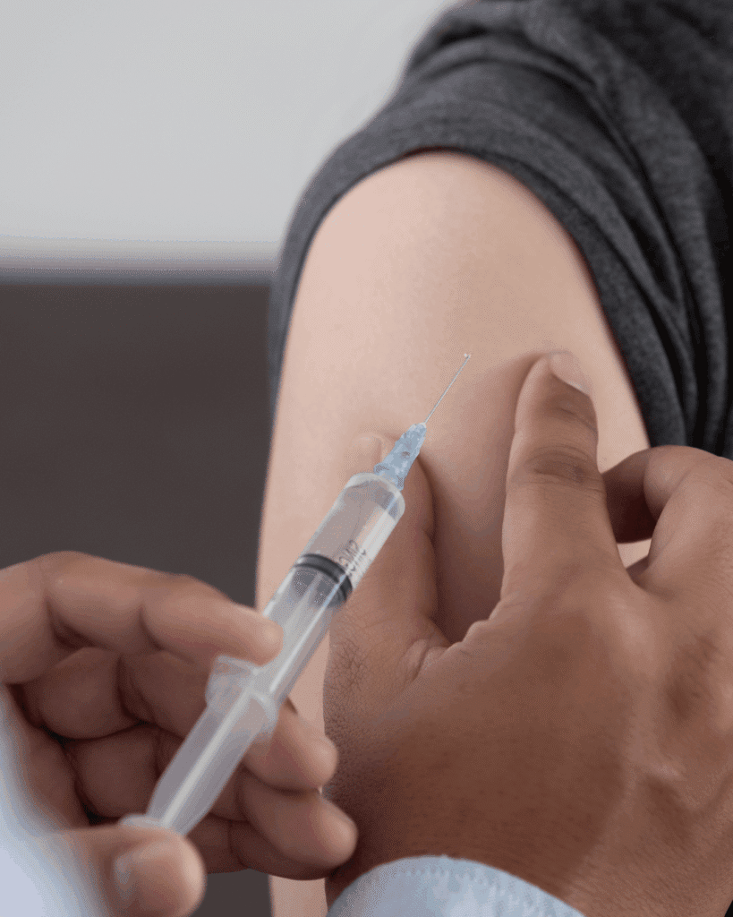 A person getting an injection in the arm