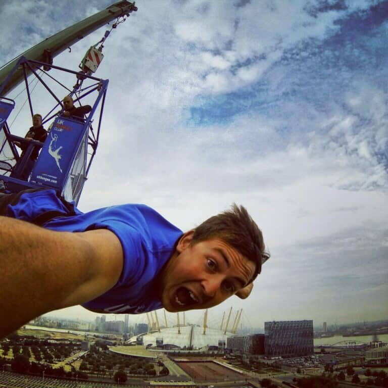 man in blue t shirt doing a bungee jump